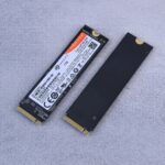 Two NVMe SSDs, Seagate FireCuda, on a gray background for tech enthusiasts.
